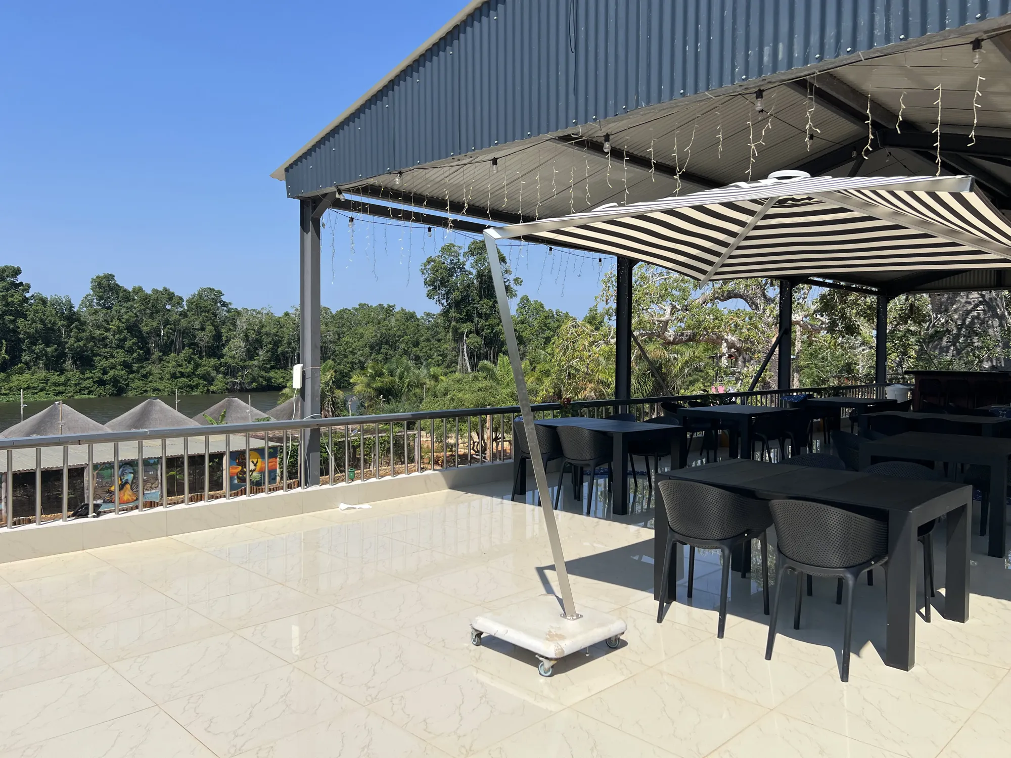 Covered dining terrace with views across the river